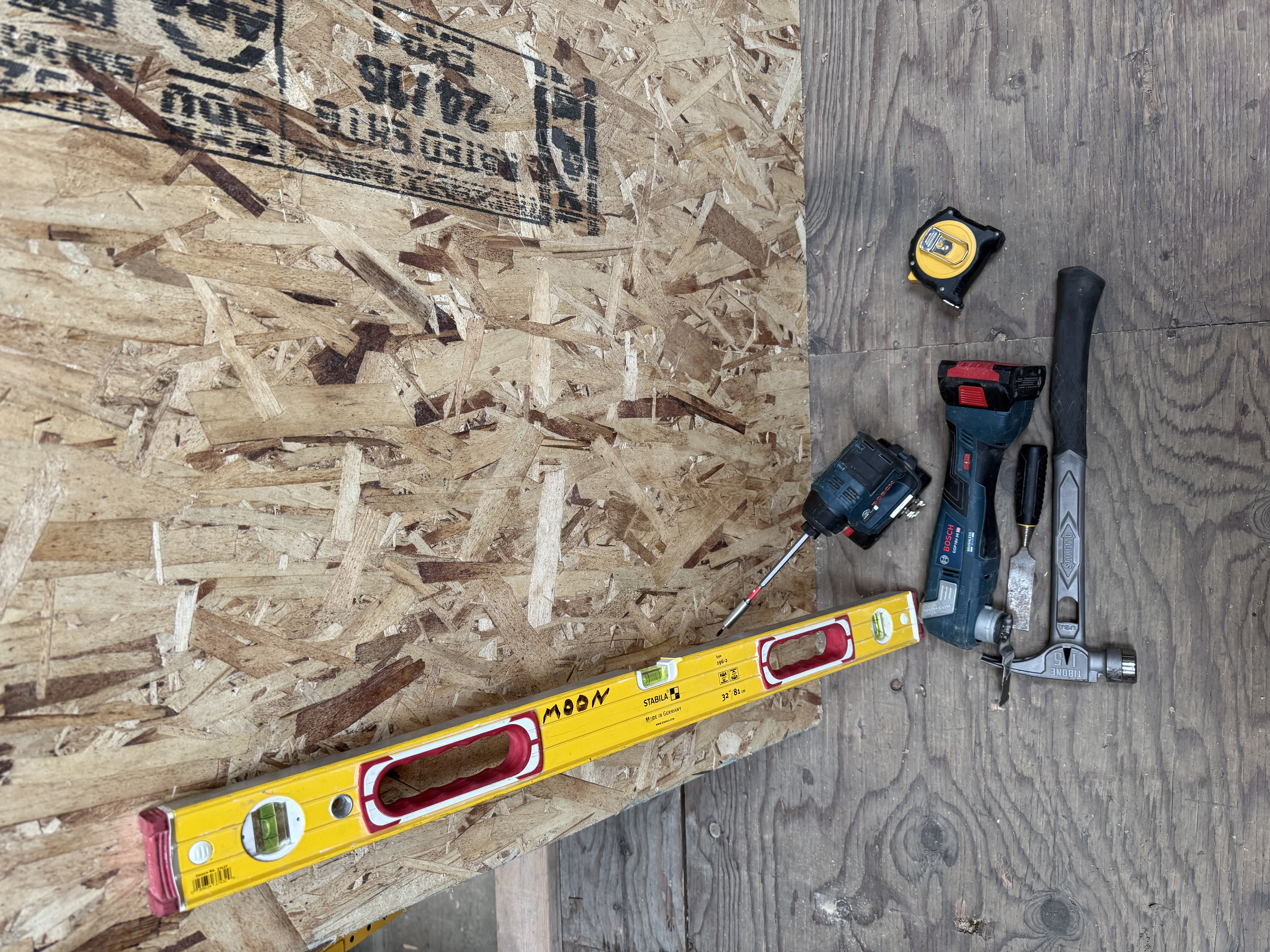 Field tools — level, oscillating tool, hammer, tape measure